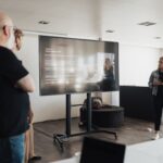 Business team engaged in a corporate presentation in a modern office space.